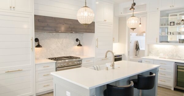 Clean white custom kitchen cabinetry installation with natural light showcasing precision millwork craftsmanship