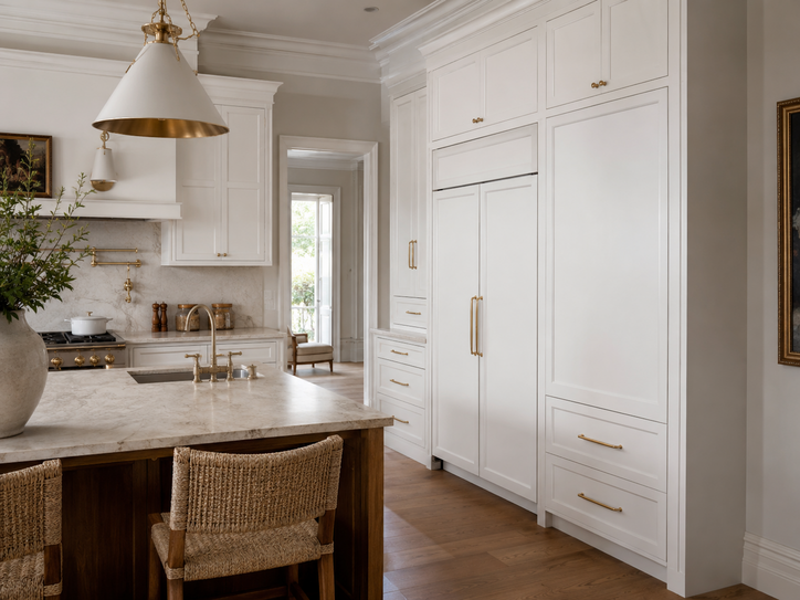 Custom kitchen cabinetry with white painted shaker doors and integrated refrigerator panel