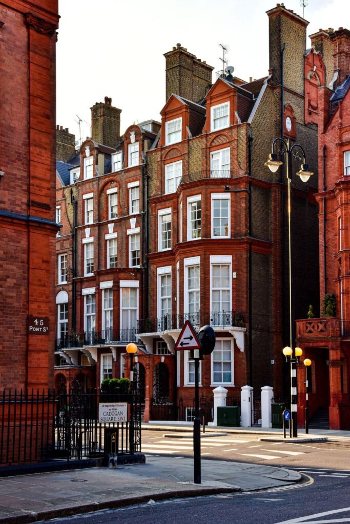A row of red-brick Victorian townhouses with period detailing